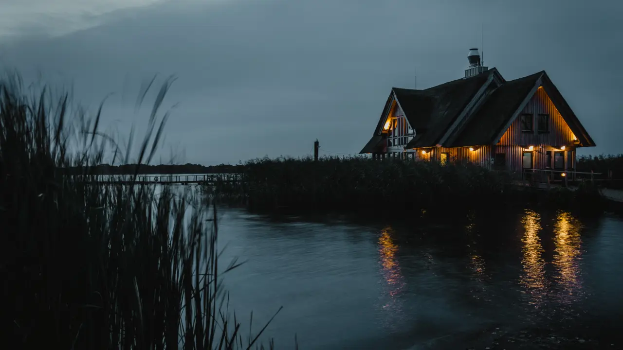 Cabin Glow By The Lake – black and grey desktop wallpaper, 5120×2880