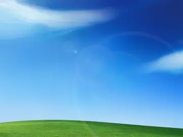 Vibrant Green Hills And Blue Sky wallpaper
